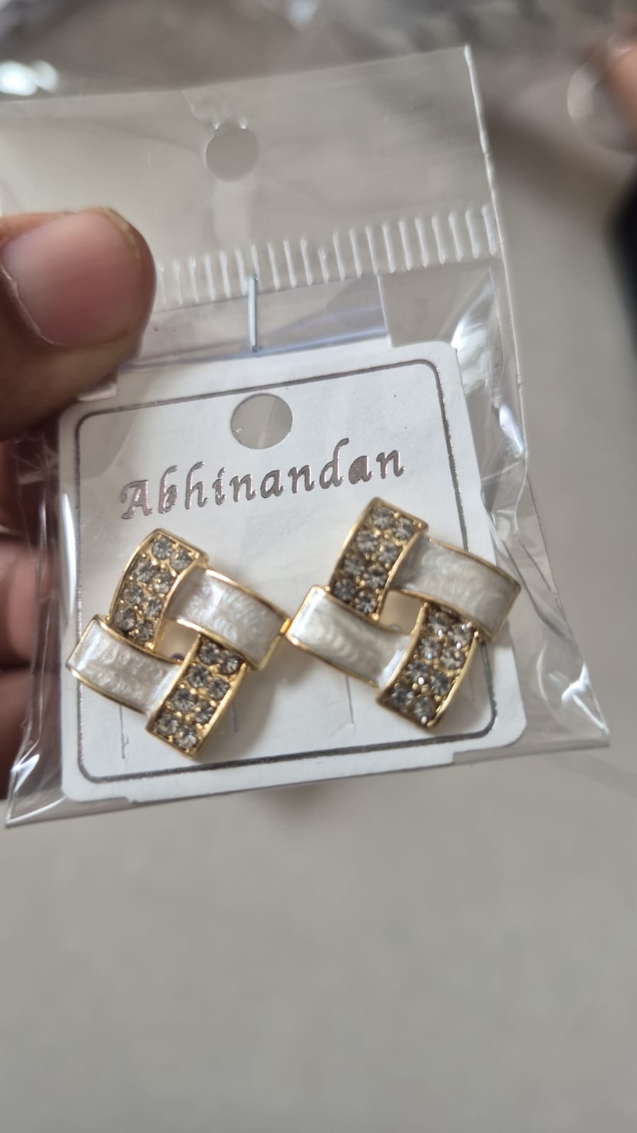 gold-plated geometric stud earrings featuring white enamel