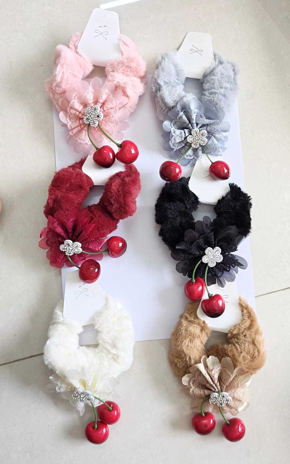 Set of 6 fluffy faux fur cherry hair scrunchies featuring a decorative crystal flower and dangling cherry charms.