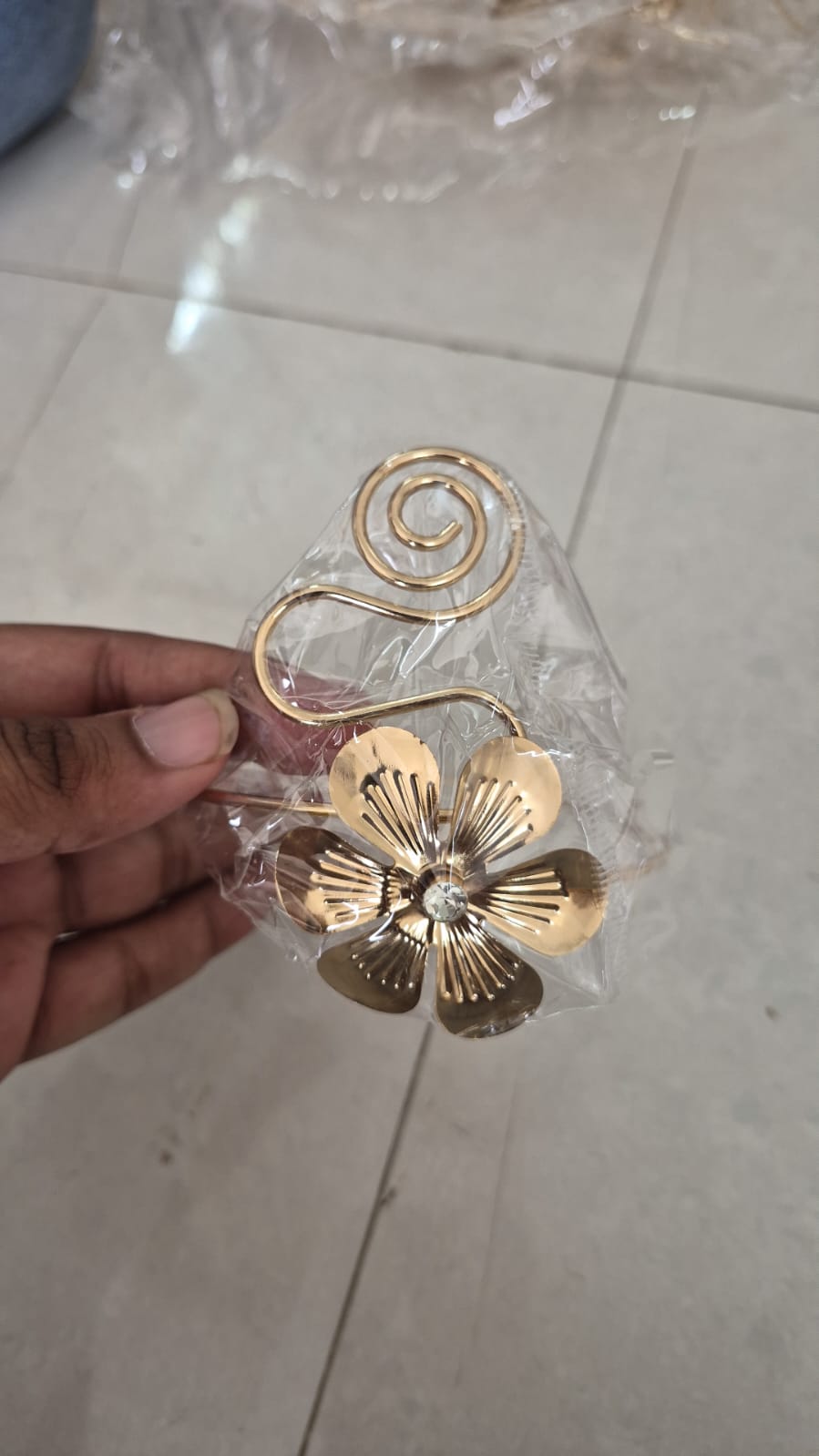Gold-toned floral arm cuff features an adjustable swirl design