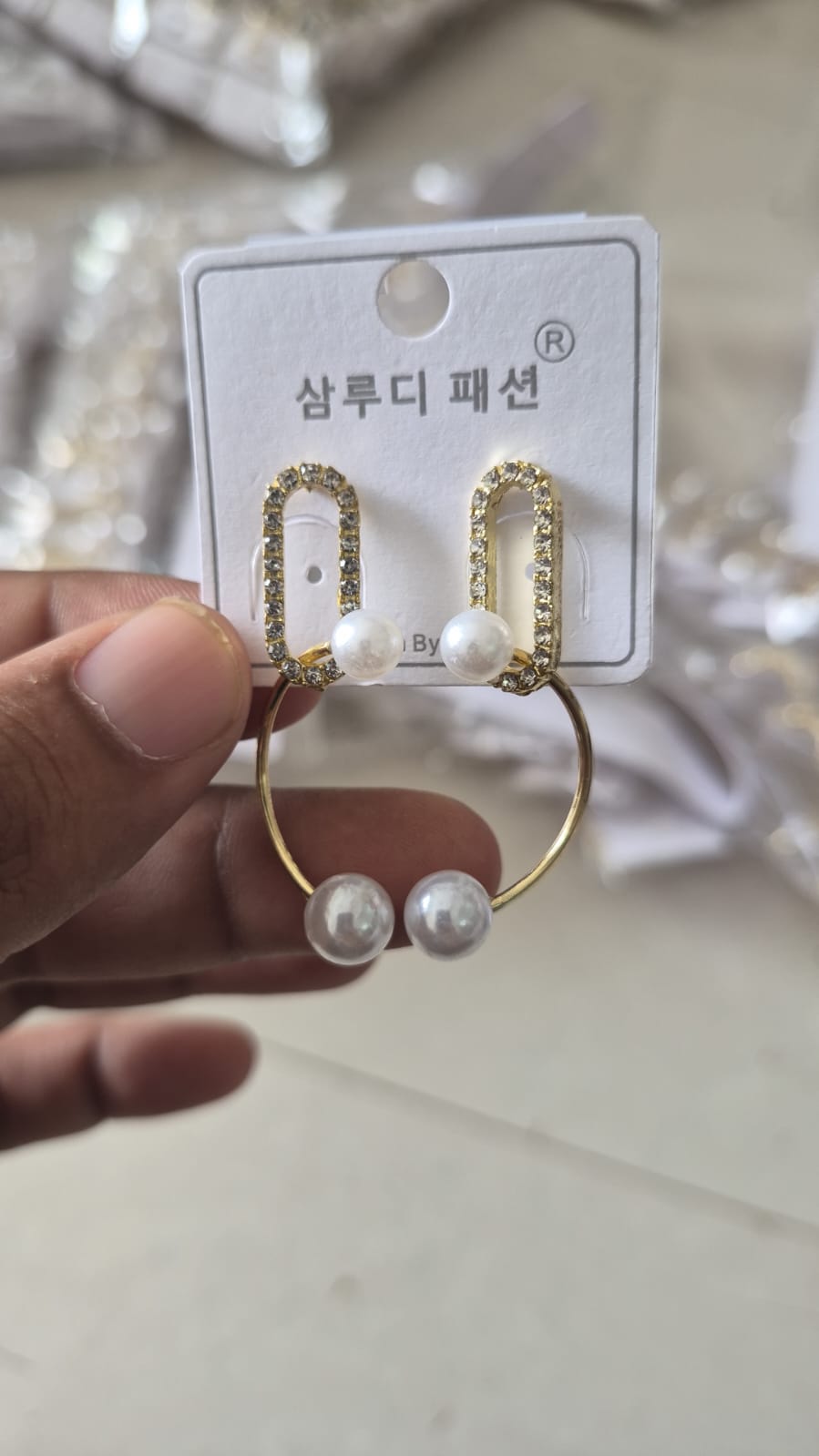 rectangular rhinestone-studded loops and faux pearl drop earrings