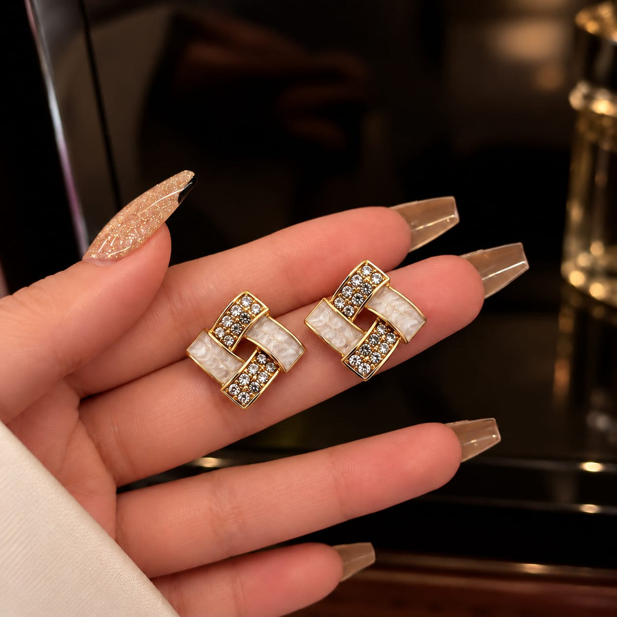 gold-plated geometric stud earrings featuring enamel