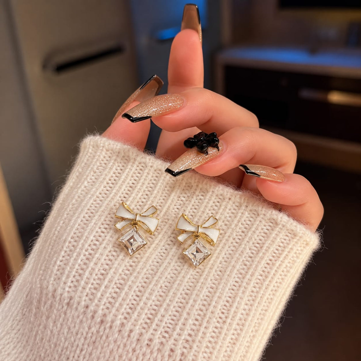 enamel bow paired with a sparkling square crystal