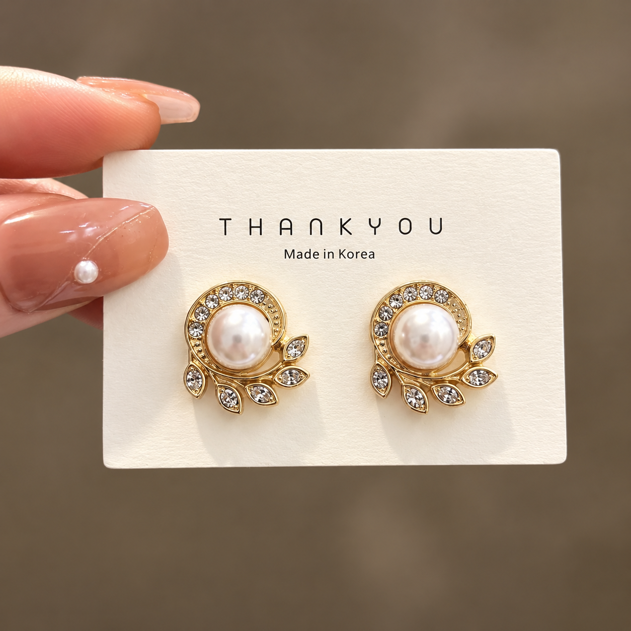 Golden-plated leaf design with pearl stud earring