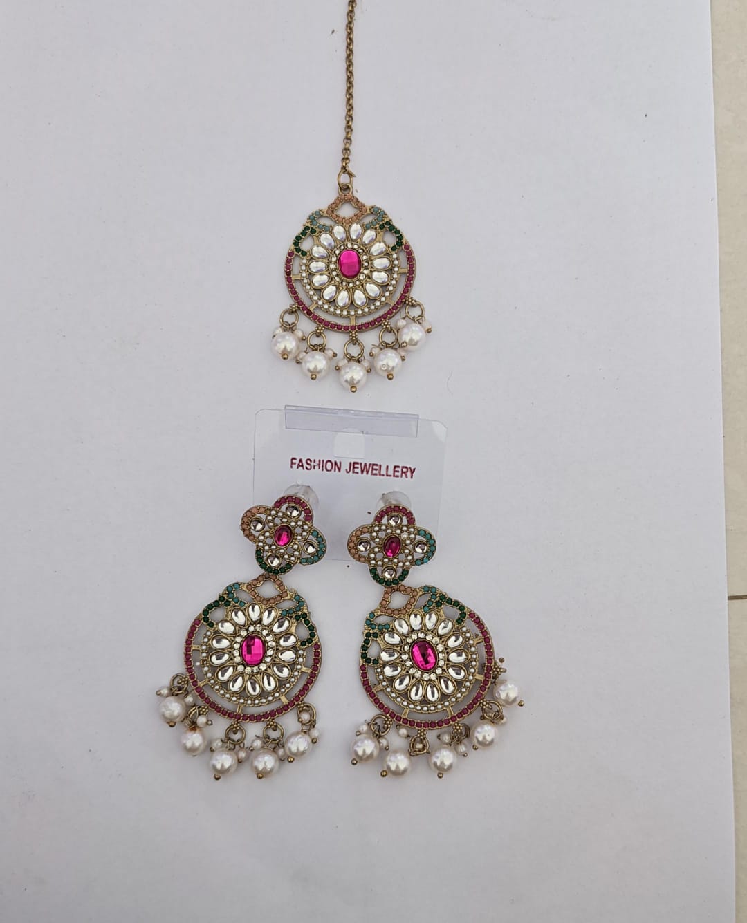 pink center stone, white kundan work drop earring with matching maang tikka
