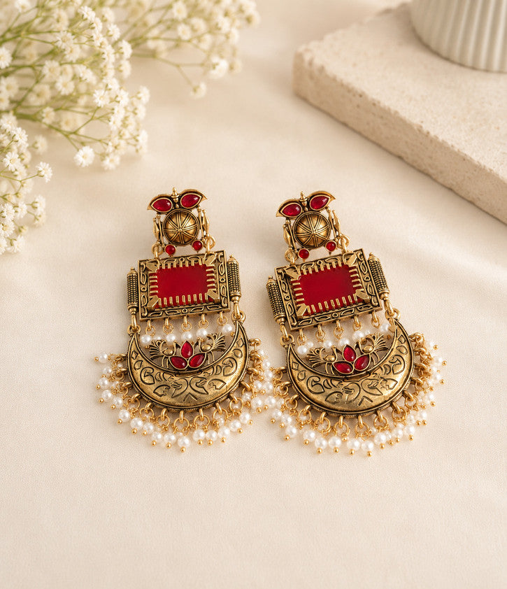 gold-toned red stone chandbali earrings featuring pearl drop