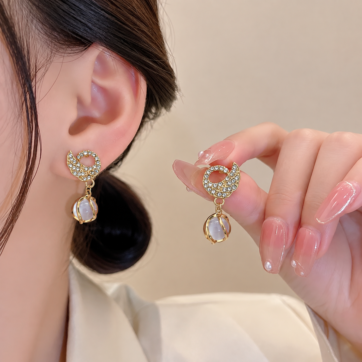 swan drop earring feature sparkling crystal-set