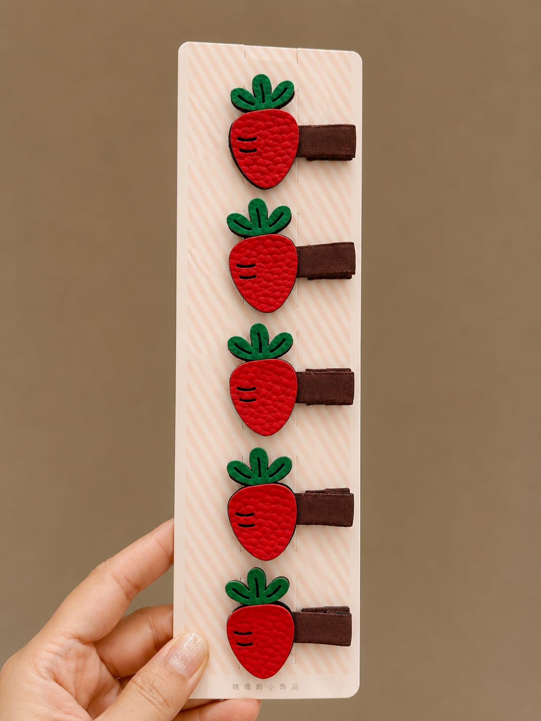 Set of five red faux strawberry hair clips with green fabric leaves