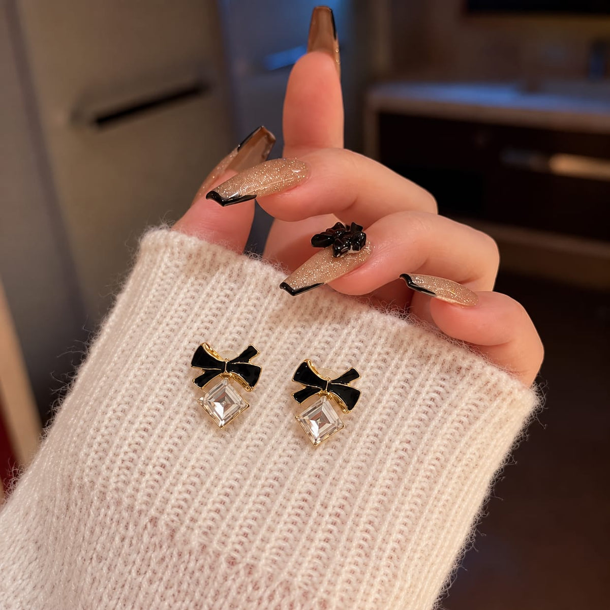 enamel bow paired with a sparkling square crystal