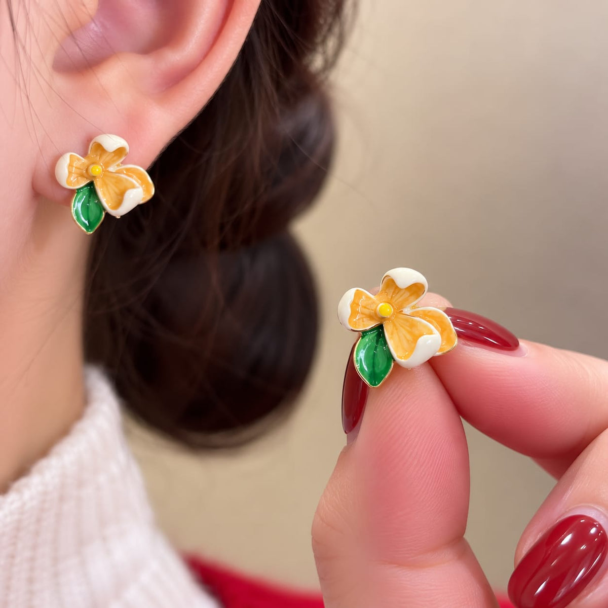 Flower Stud Earrings, featuring colorful enamel floral designs with green leaf accents.