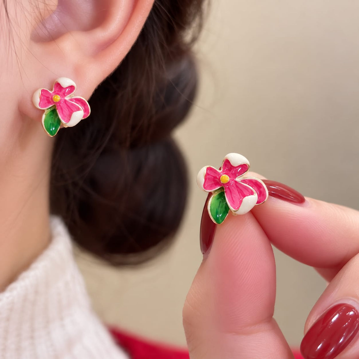 Flower Stud Earrings, featuring colorful enamel floral designs with green leaf accents.