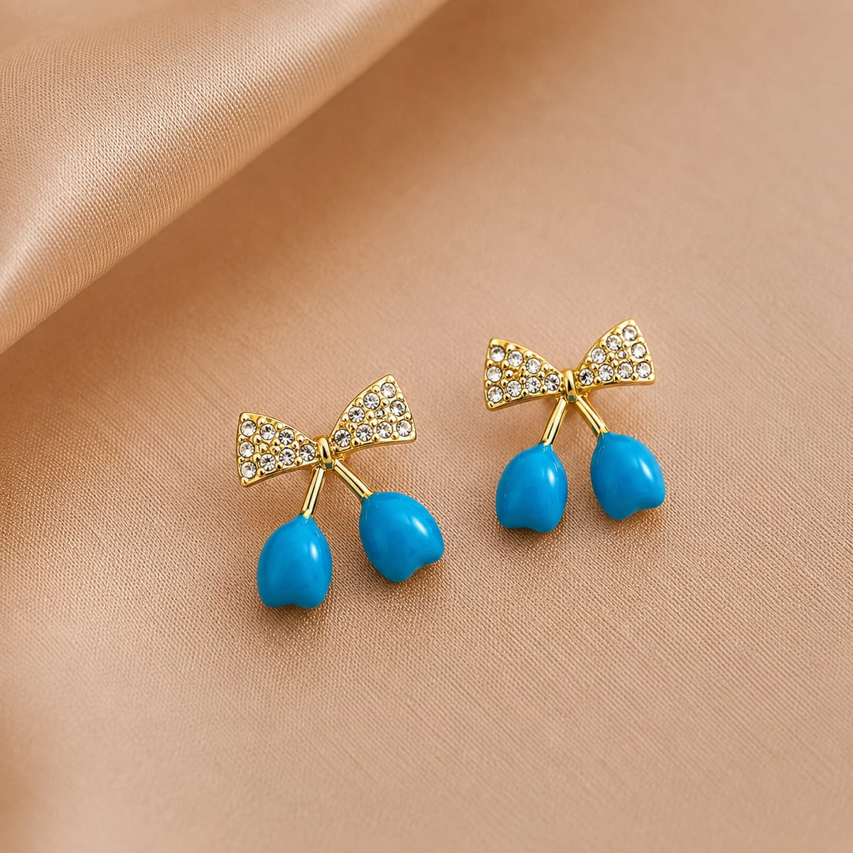 crystal bows paired with glossy cherry drop charms.