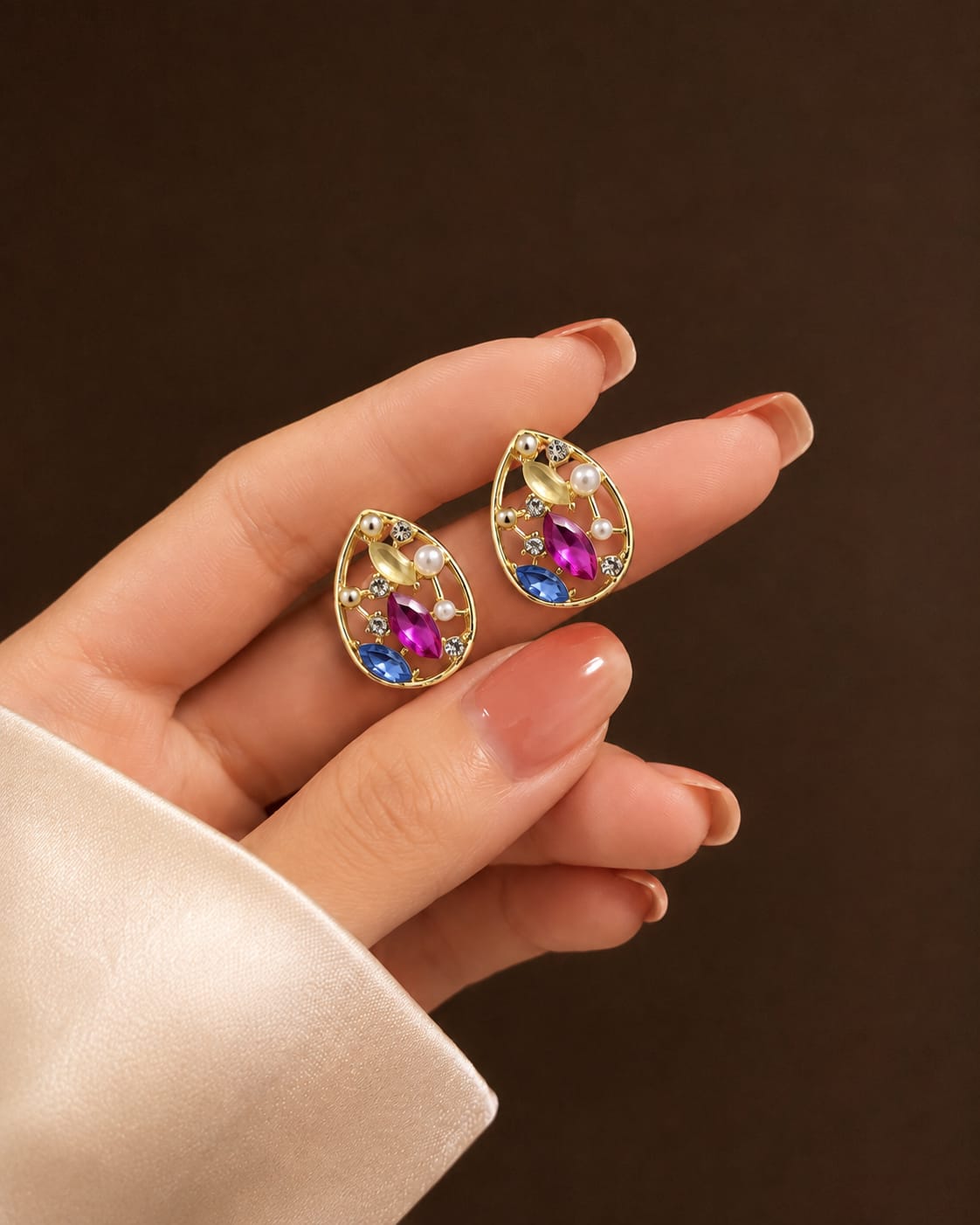 teardrop earrings with rhinestones along with faux pearls.