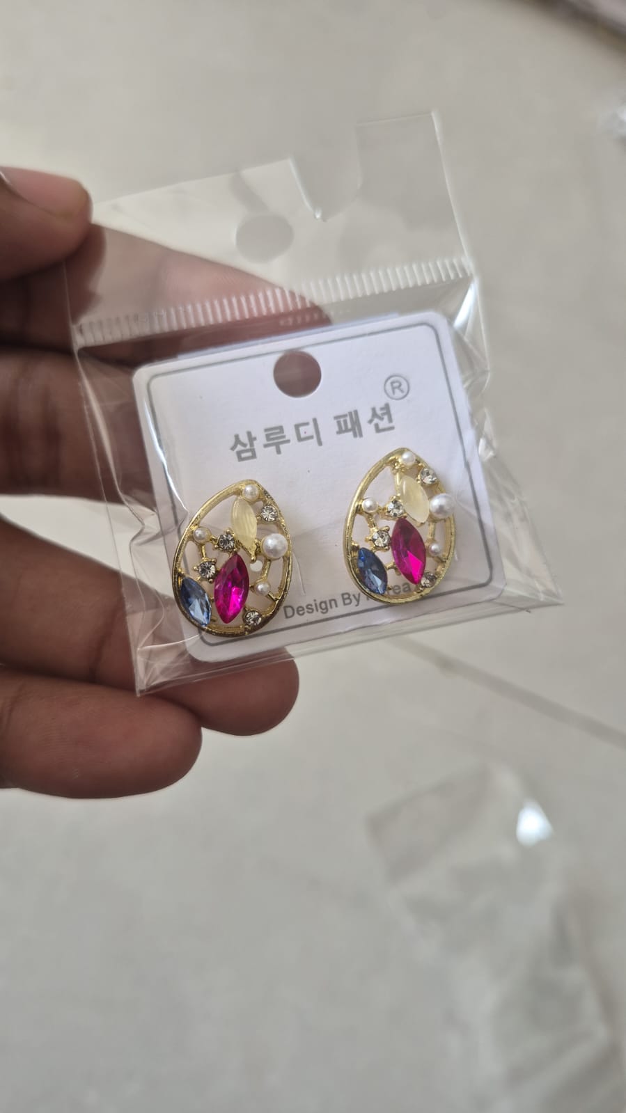 teardrop earrings with rhinestones along with faux pearls.