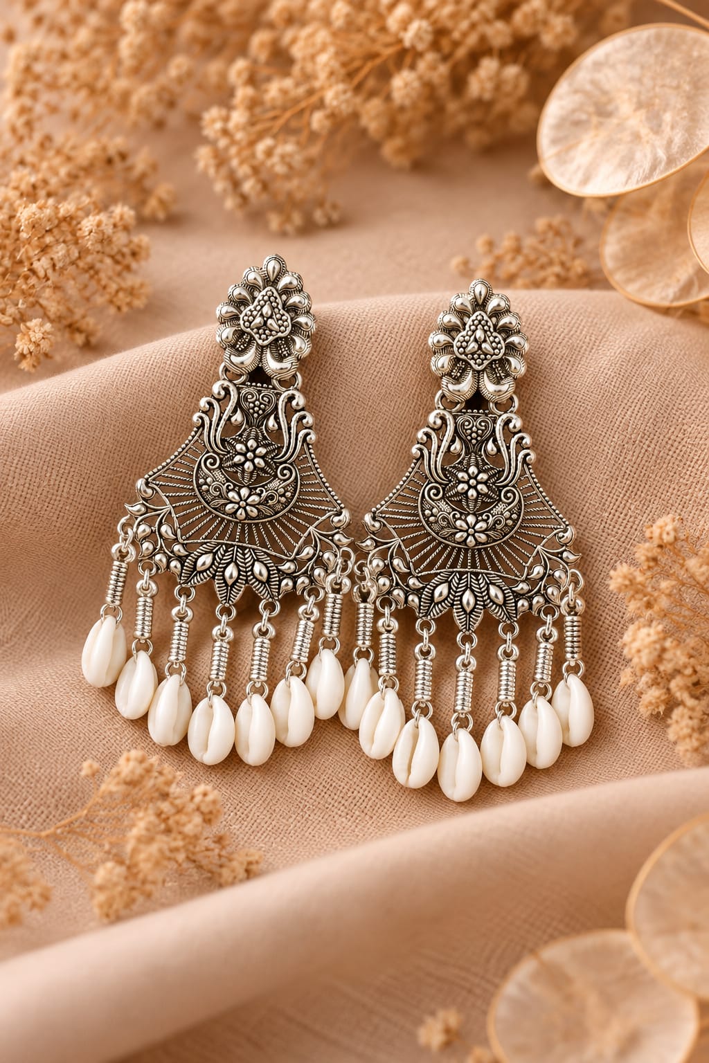 oxidized silver-plated cowrie shell and floral design drop earring